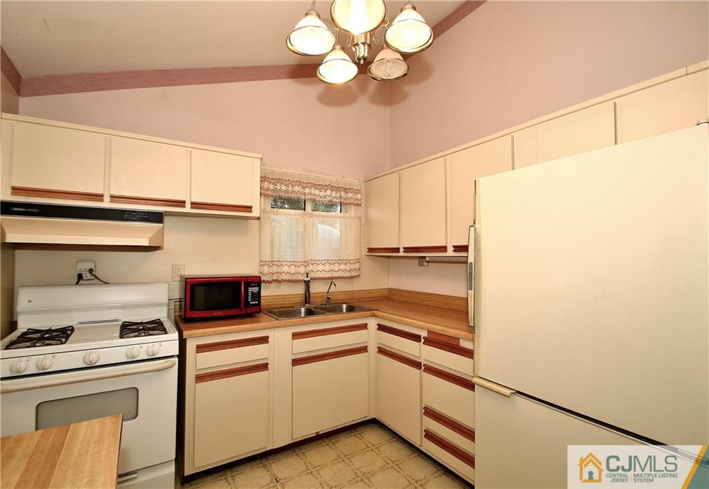 35 Rieder Road Spotswood, NJ 08884 - Photo 10 of 25 a kitchen with cabinets and white stainless steel appliances
