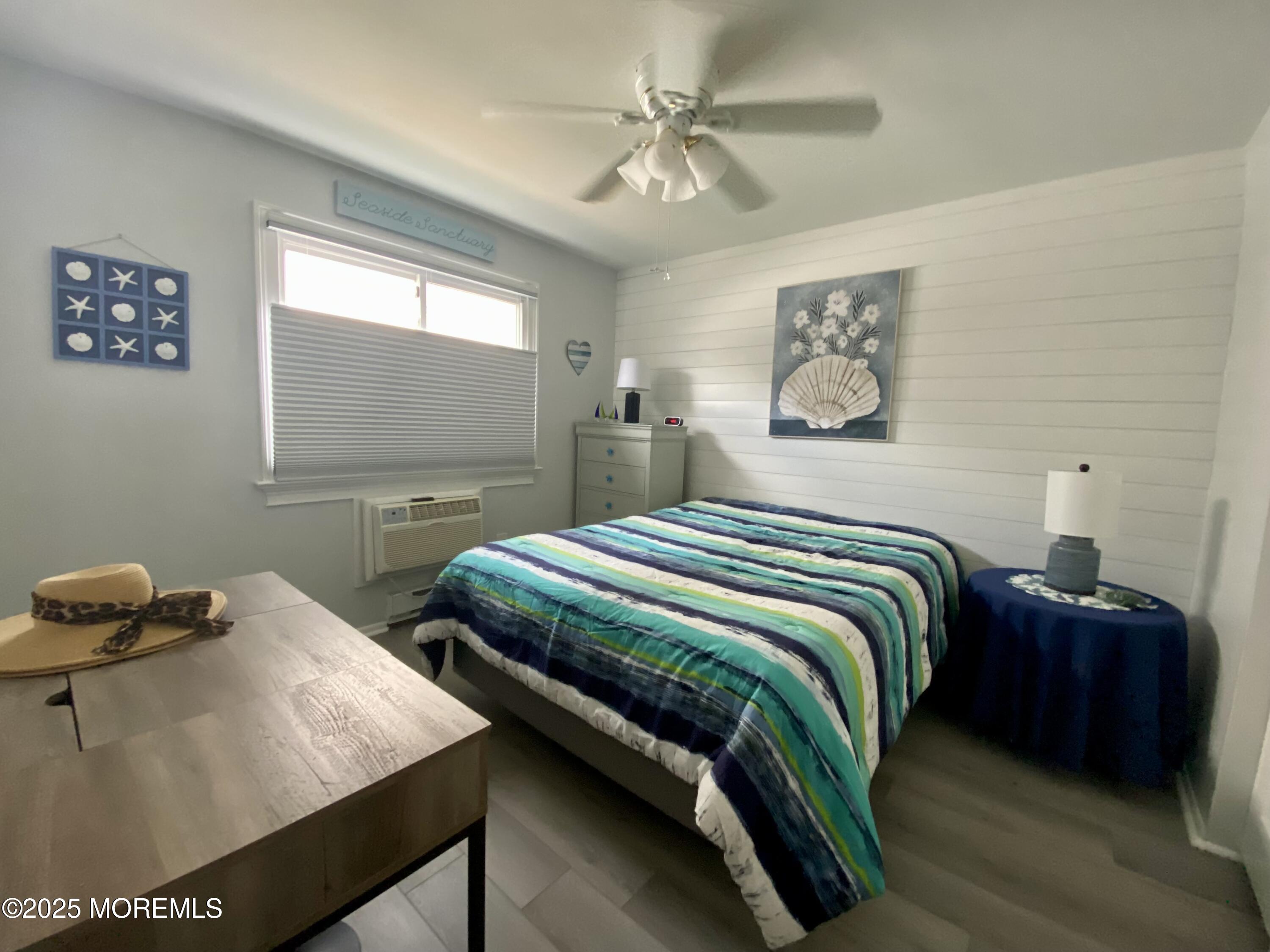 260 Ocean Avenue, Unit A18 Sea Bright, NJ 07760 - Photo 11 of 19 a bedroom with two beds and a chandelier