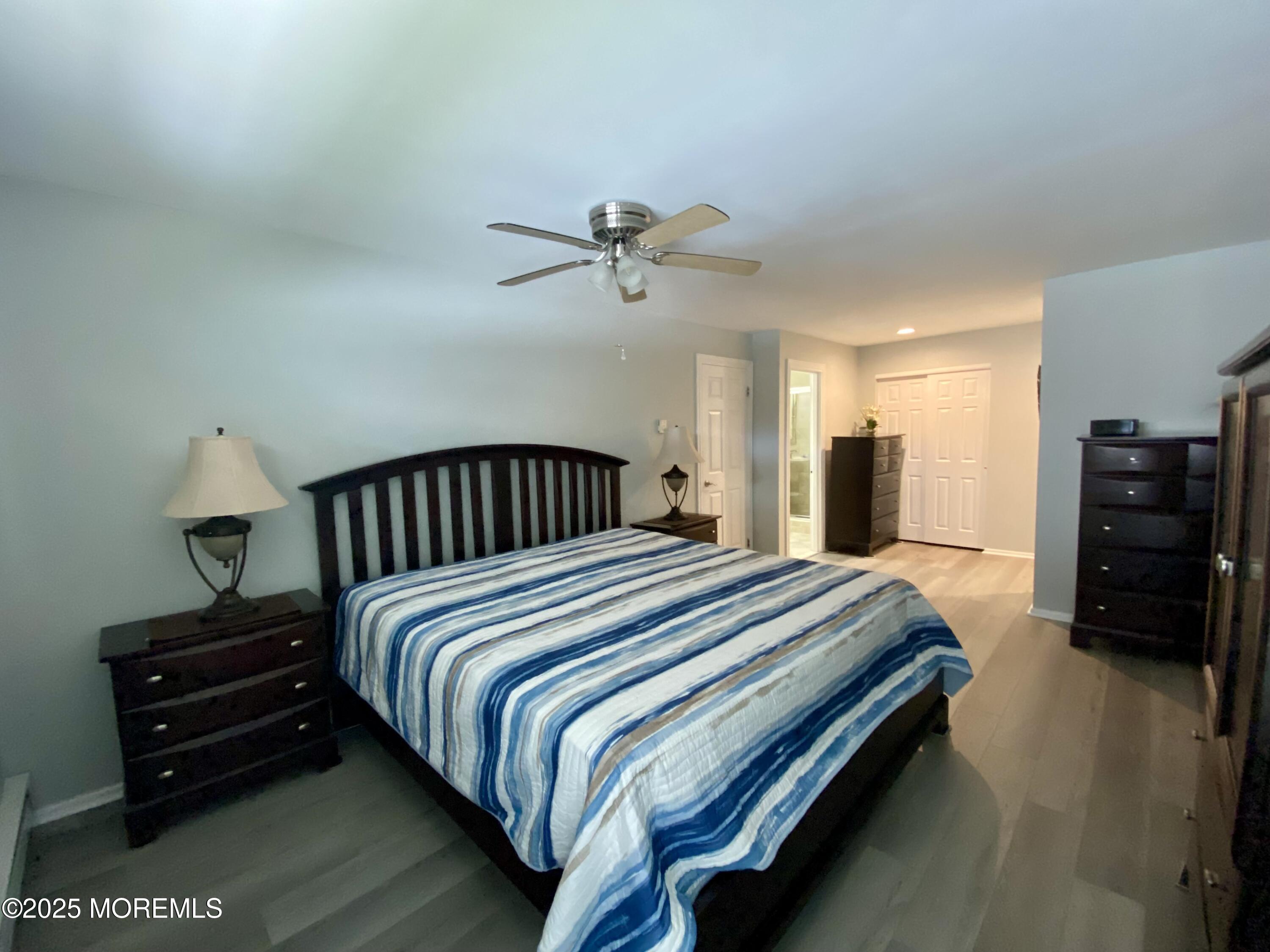 260 Ocean Avenue, Unit A18 Sea Bright, NJ 07760 - Photo 13 of 19 a bedroom with bed and a chandelier
