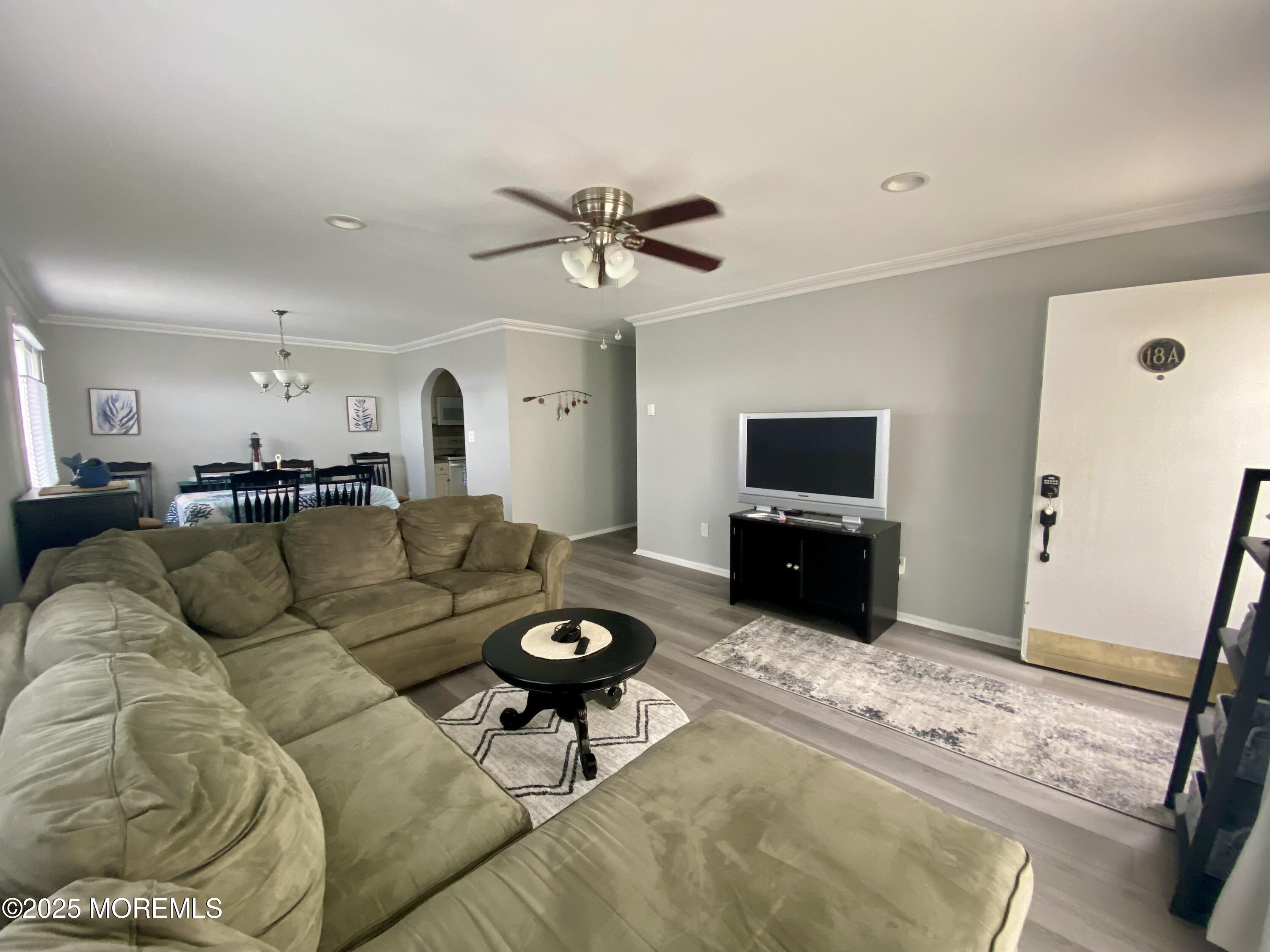 260 Ocean Avenue, Unit A18 Sea Bright, NJ 07760 - Photo 9 of 19 a living room with furniture and a flat screen tv