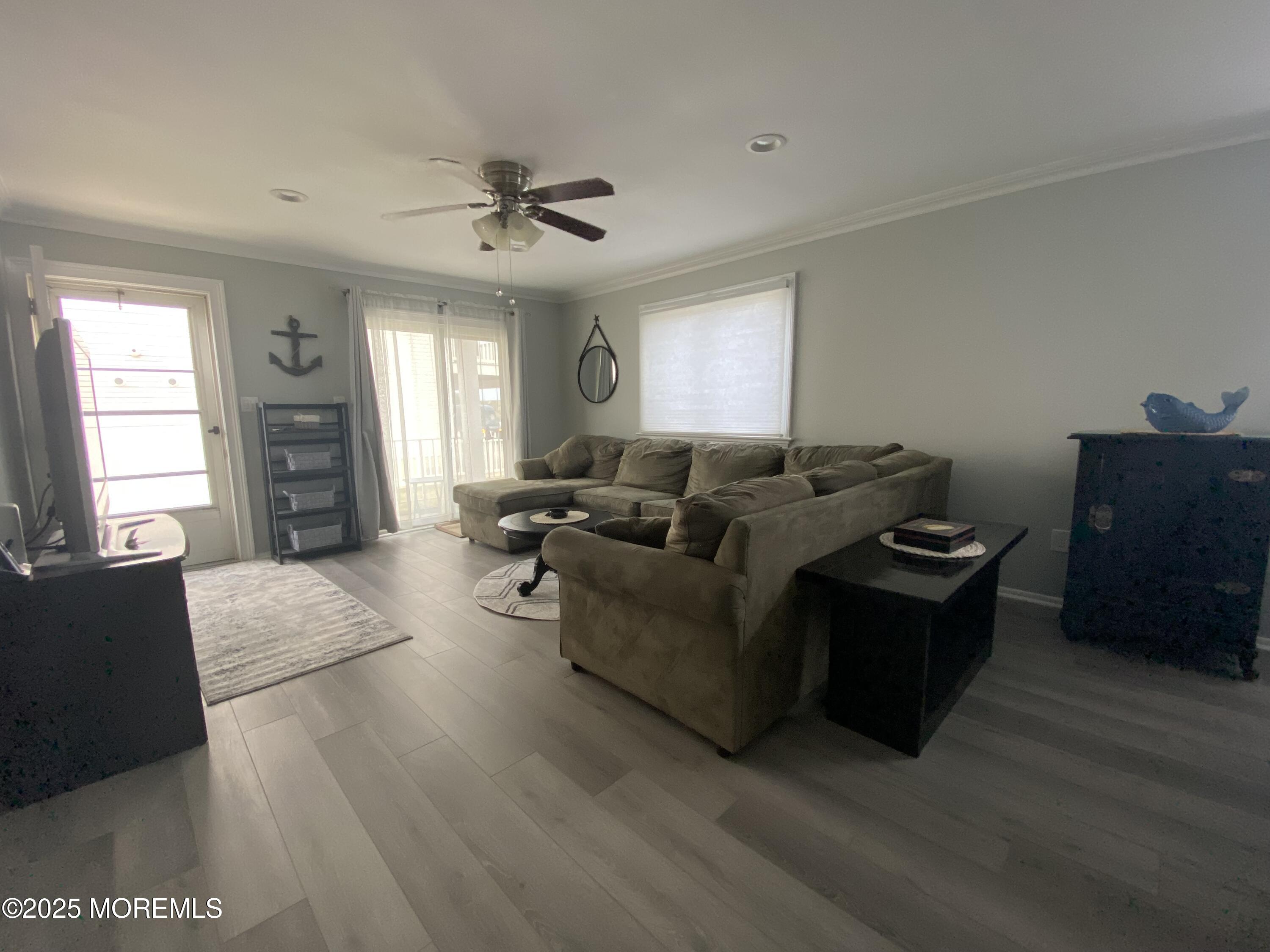 260 Ocean Avenue, Unit A18 Sea Bright, NJ 07760 - Photo 10 of 19 a living room with furniture and a flat screen tv