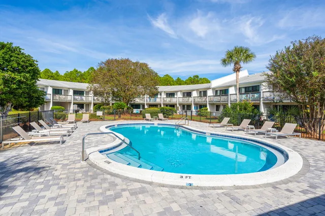 a swimming pool view with a seating space