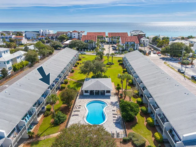 a view of a hallway with wooden floor and stairs