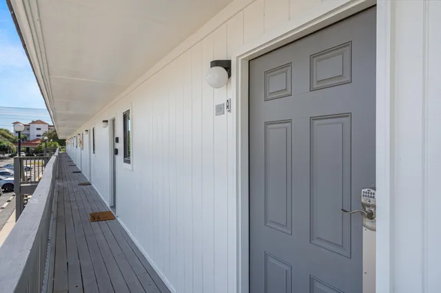 a view of a hallway with closet and a window