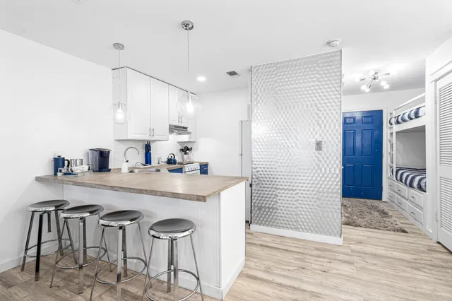 a kitchen with stainless steel appliances granite countertop a sink a stove and cabinets