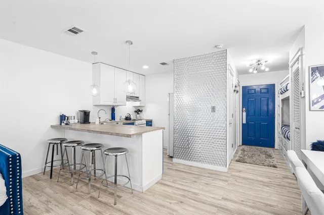 a kitchen with granite countertop a sink and a wooden cabinets