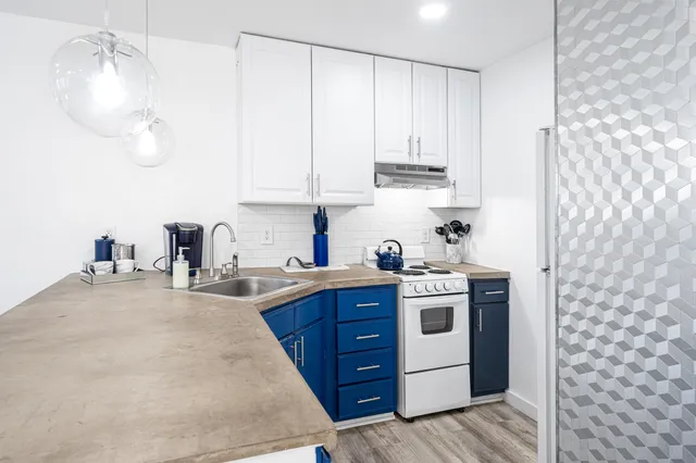 a kitchen with stainless steel appliances granite countertop a sink stove and cabinets