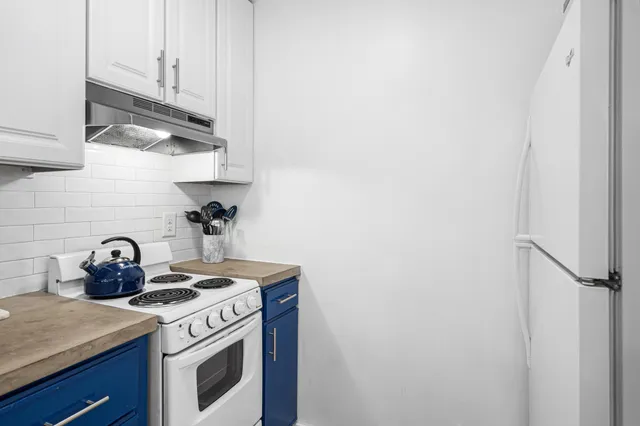 a kitchen with a stove a sink and a refrigerator