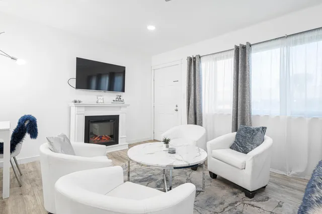 a living room with kitchen island furniture and a wooden floor