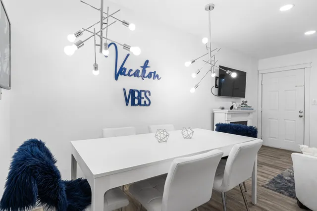 a kitchen with a table chairs window and cabinets