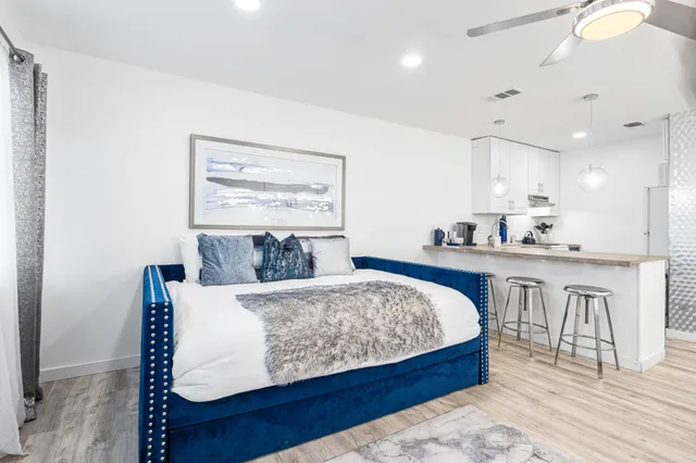 a living room with furniture a fireplace and a chandelier