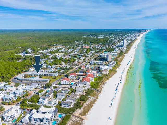 an aerial view of a house with a swimming pool and outdoor seating