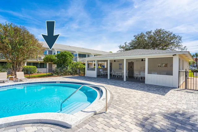 a view of a house with swimming pool and sitting area