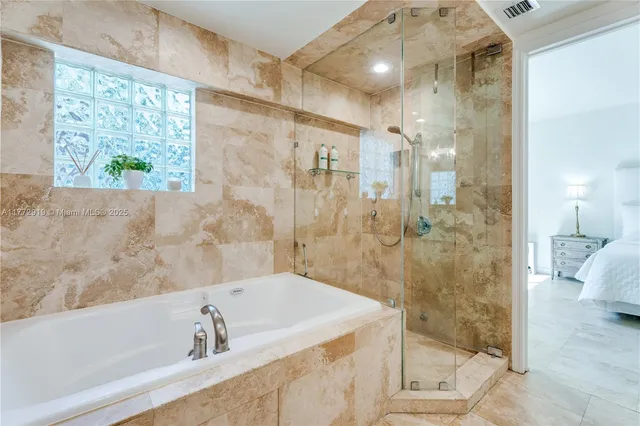 a bathroom with a bathtub and shower