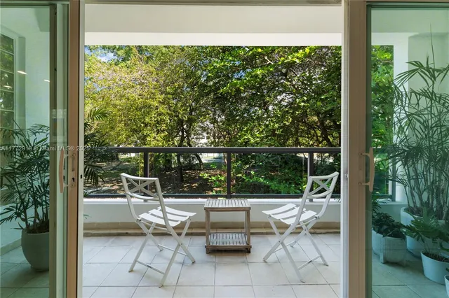 a balcony with chairs and potted plants