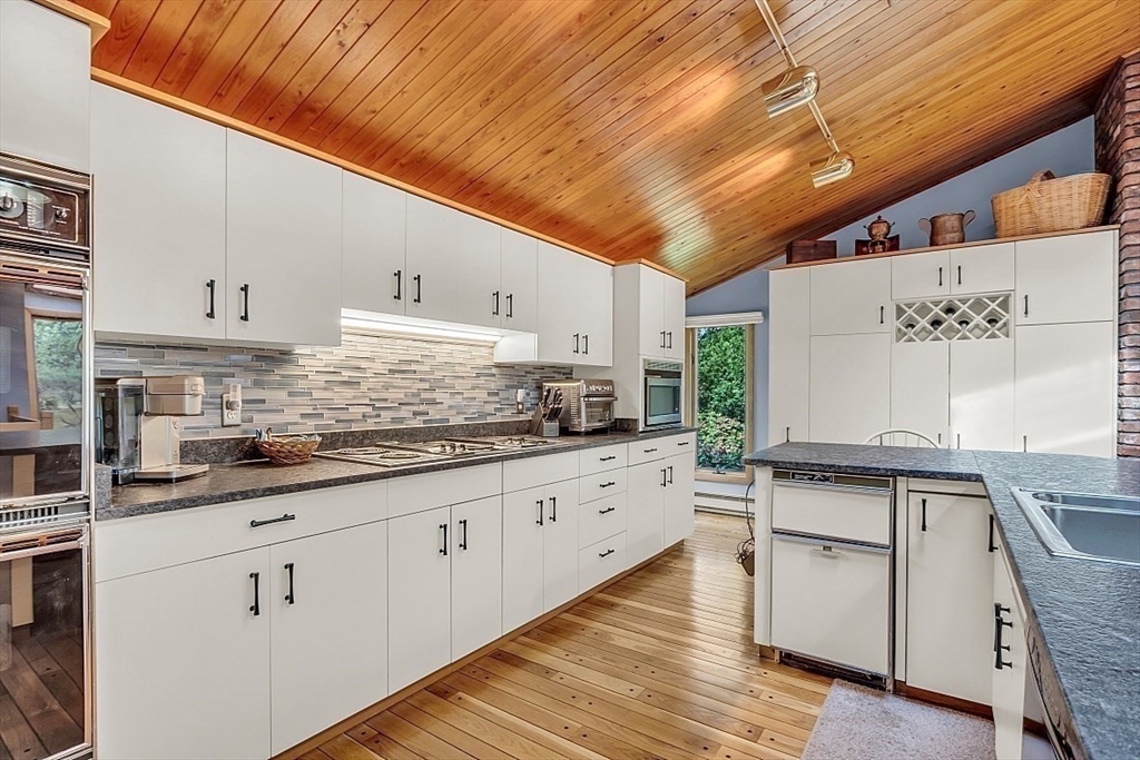4 Belfast Road Peabody, MA 01960 - Photo 12 of 34 a kitchen with granite countertop wooden cabinets and white appliances