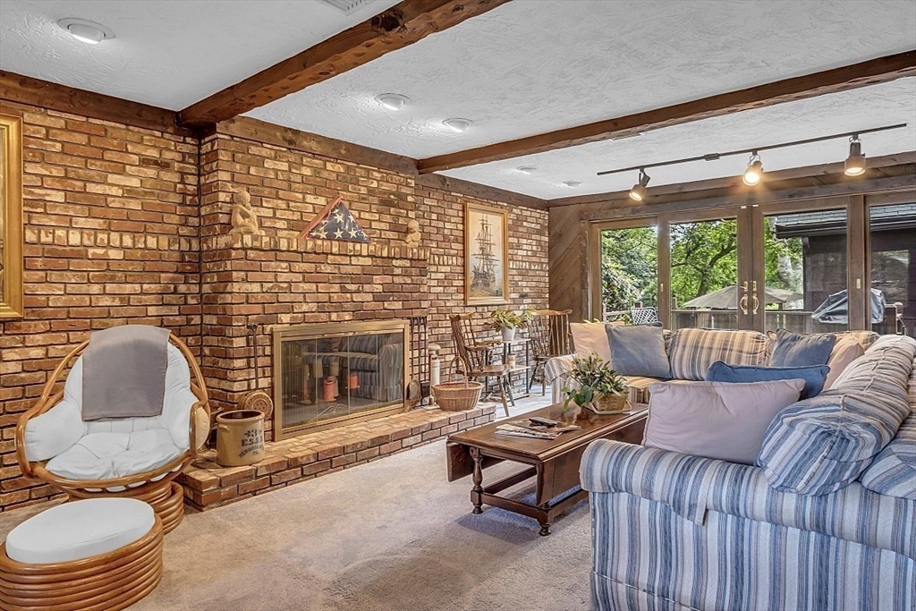 4 Belfast Road Peabody, MA 01960 - Photo 16 of 34 a living room with furniture and a fireplace