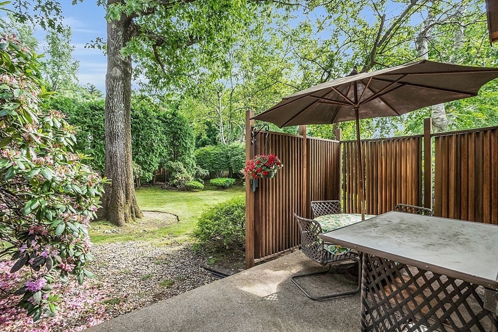 4 Belfast Road Peabody, MA 01960 - Photo 30 of 34 a backyard of a house with table and chairs under an umbrella
