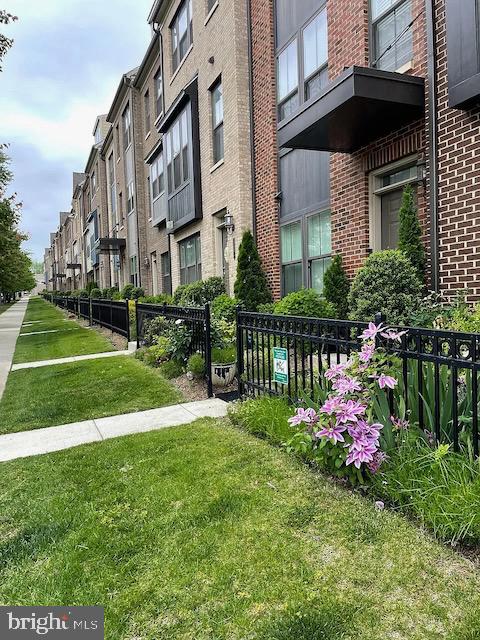 Charming townhomes with vibrant landscaping.