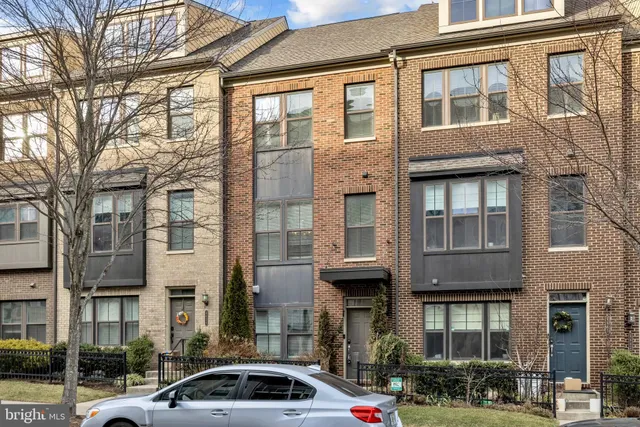 a front view of a building with car parked