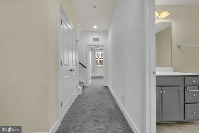 a view of a hallway with wooden floor and entryway