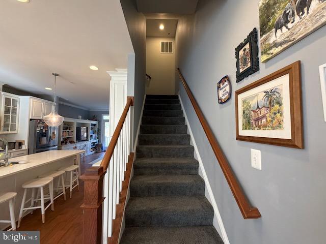 4638 Woodberry Street Riverdale, MD 20737 - Photo 28 of 78 Inviting staircase leads to cozy upper retreat.