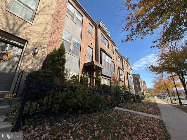4638 Woodberry Street Riverdale, MD 20737 - Photo 55 of 78 Charming townhomes under a clear blue sky.