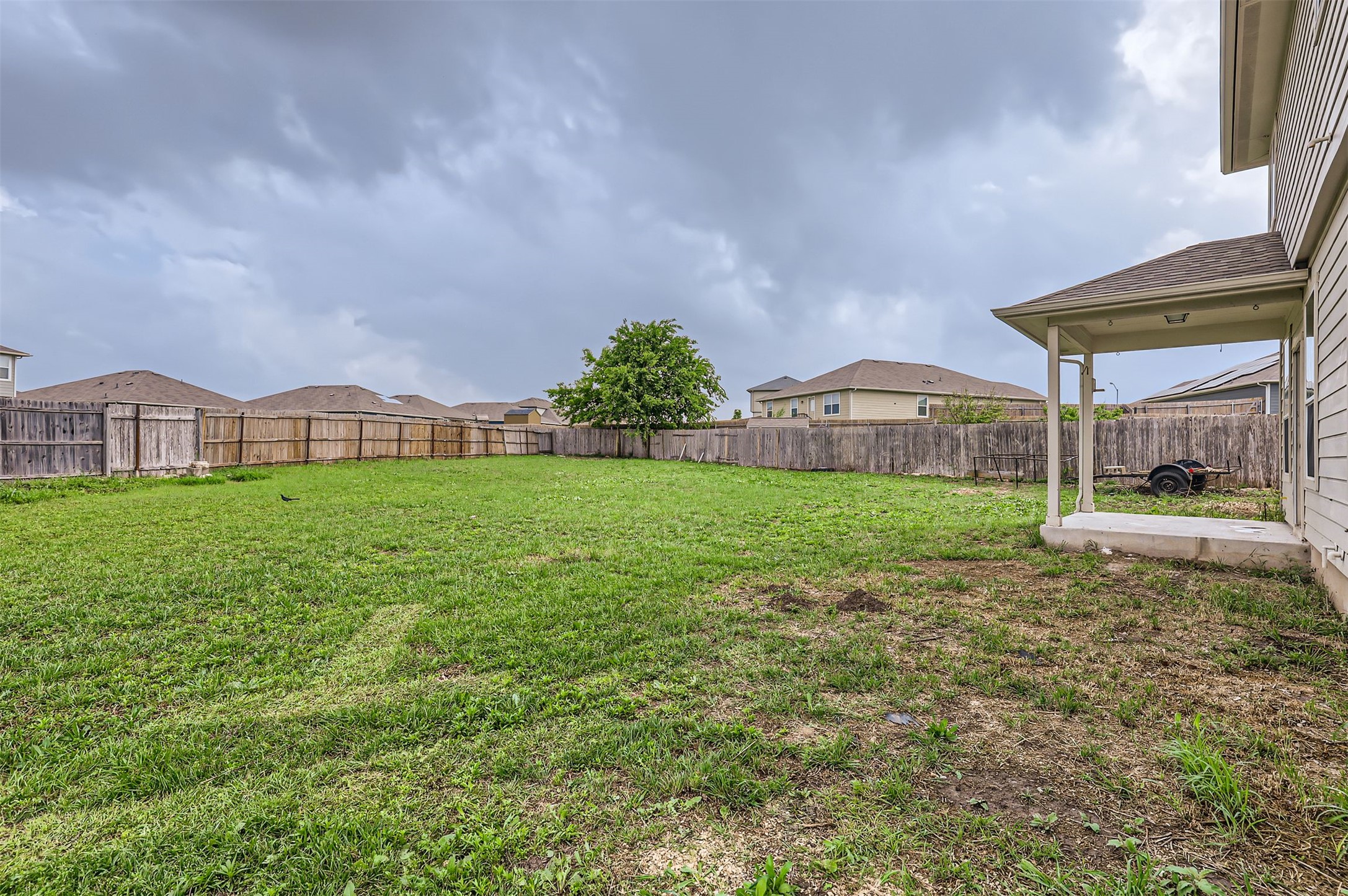 131 Lavaca Loop Hutto, TX 78634 - Photo 27 of 29 A generously sized yard, fenced for seclusion, awaits your personal touch under an open sky.