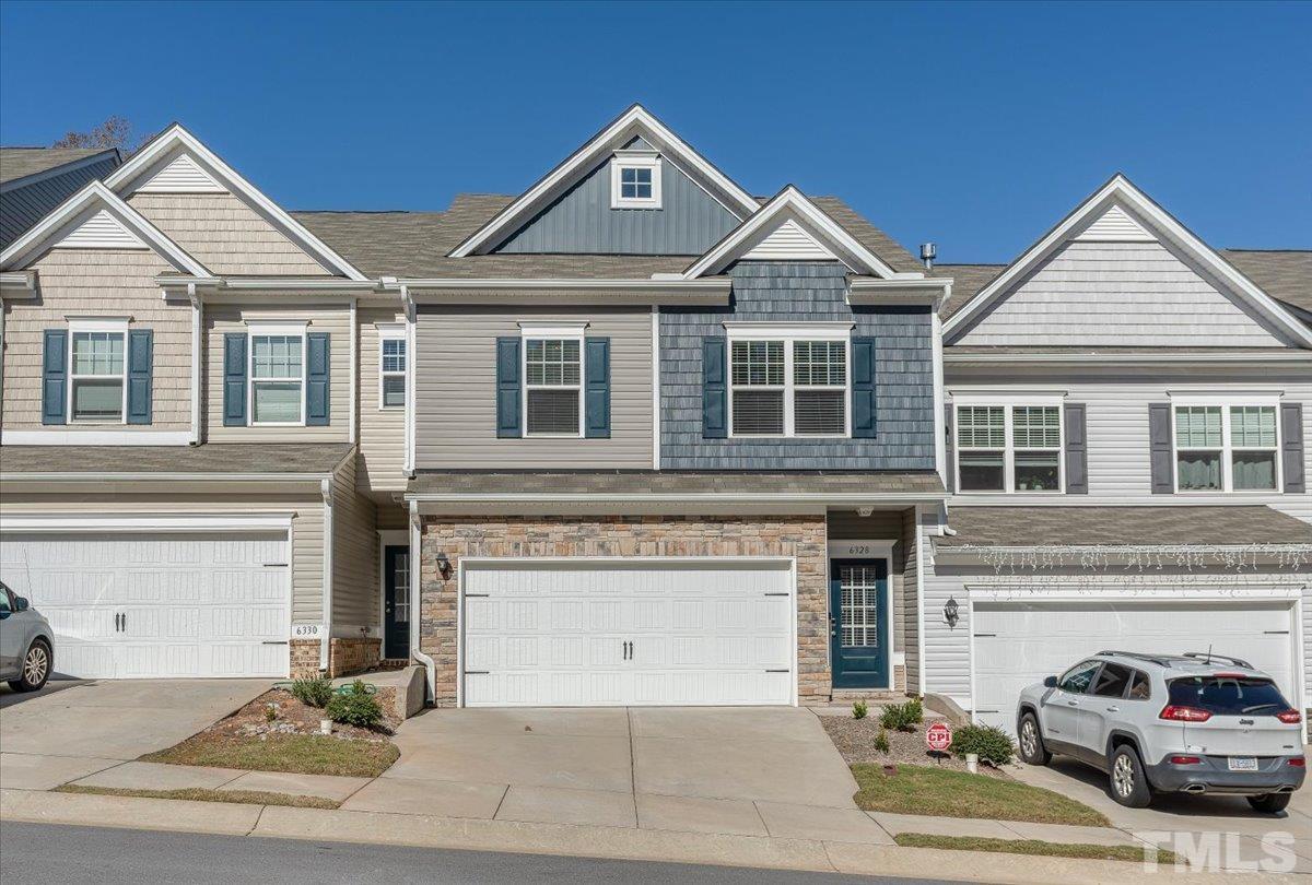 6328 Grace Lily Drive Raleigh, NC 27607 - Photo 1 of 27 a front view of a house with a yard and parking space