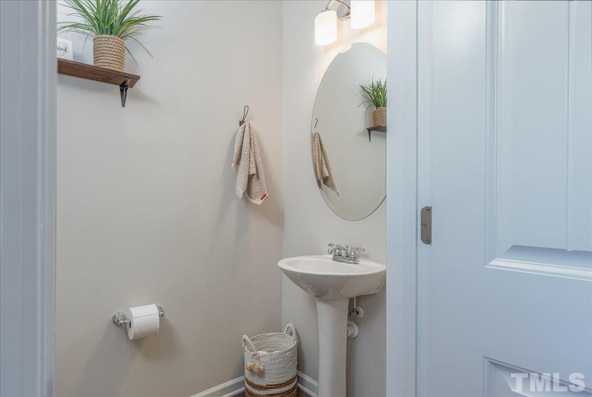 6328 Grace Lily Drive Raleigh, NC 27607 - Photo 13 of 27 a bathroom with a sink and mirror