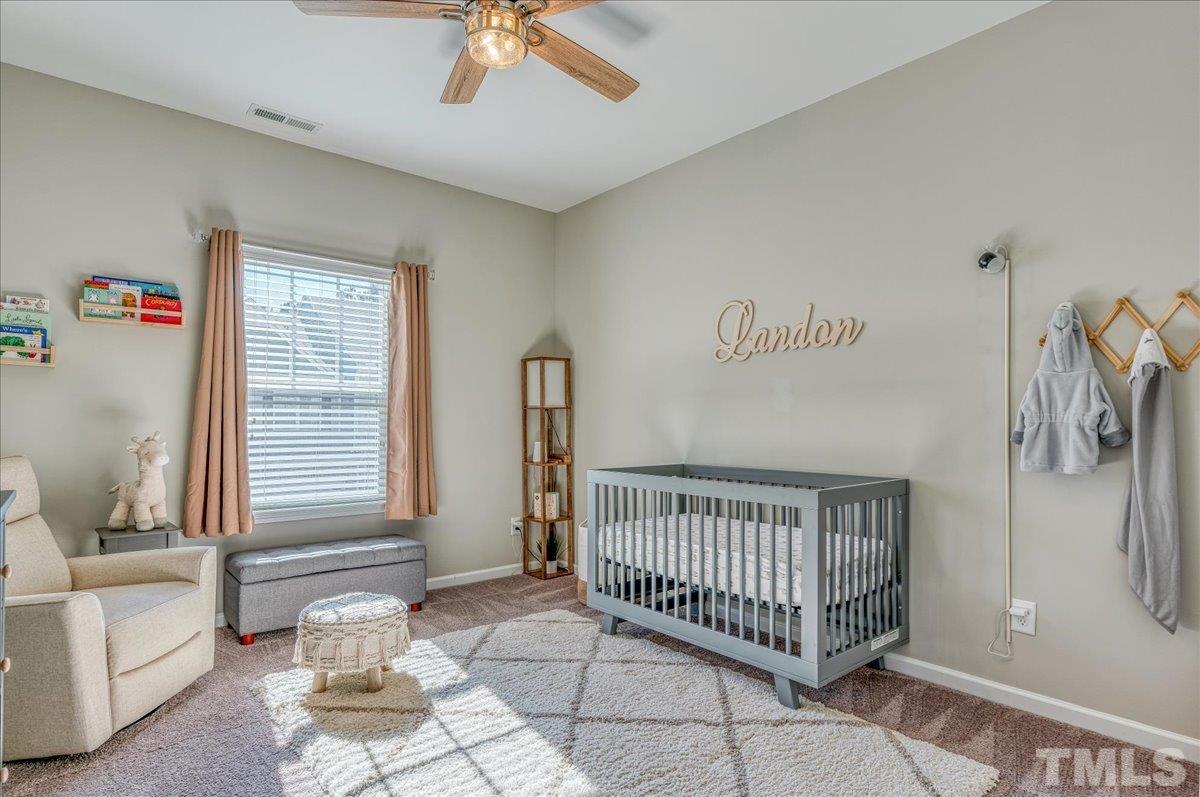 6328 Grace Lily Drive Raleigh, NC 27607 - Photo 16 of 27 a view of a bedroom with furniture and staircase