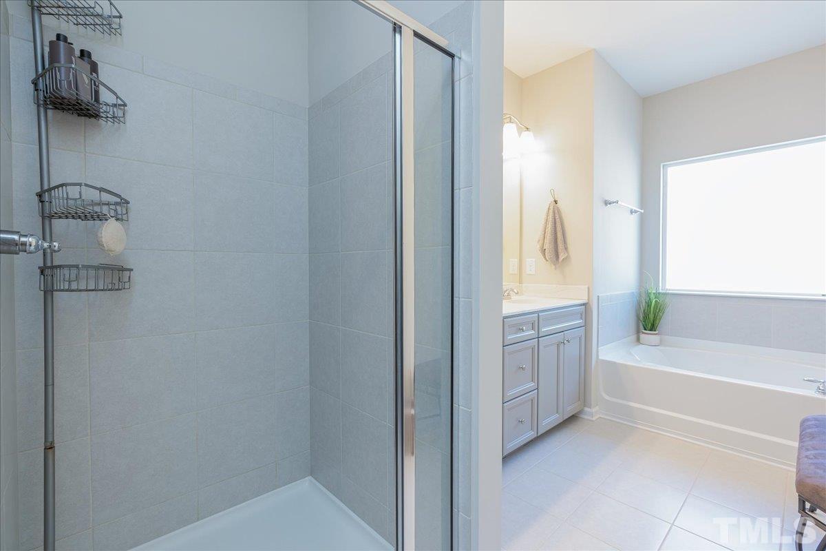 6328 Grace Lily Drive Raleigh, NC 27607 - Photo 23 of 27 a bathroom with a tub sink and vanity
