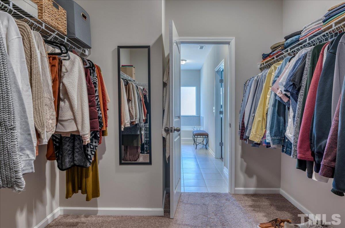 6328 Grace Lily Drive Raleigh, NC 27607 - Photo 24 of 27 a view of walk in closet with clothes and shoes