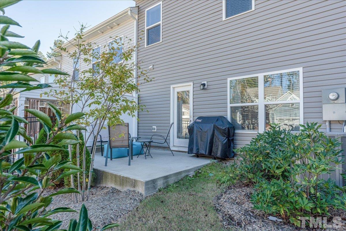 6328 Grace Lily Drive Raleigh, NC 27607 - Photo 26 of 27 a view of a house with backyard and sitting area