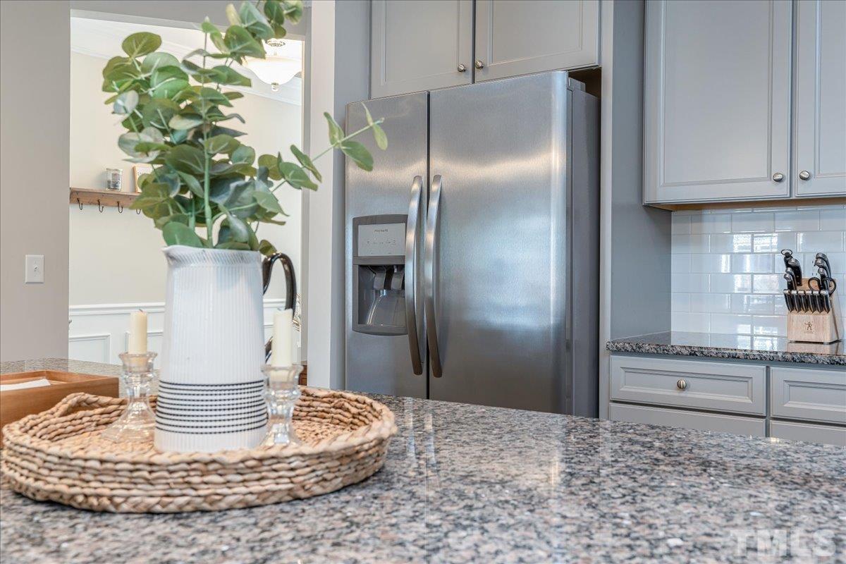 6328 Grace Lily Drive Raleigh, NC 27607 - Photo 7 of 27 a kitchen with a refrigerator and a stove