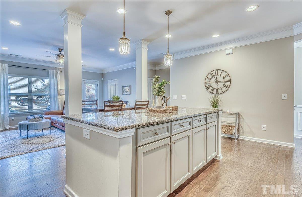 6328 Grace Lily Drive Raleigh, NC 27607 - Photo 8 of 27 a kitchen with a sink and a clock on the wall