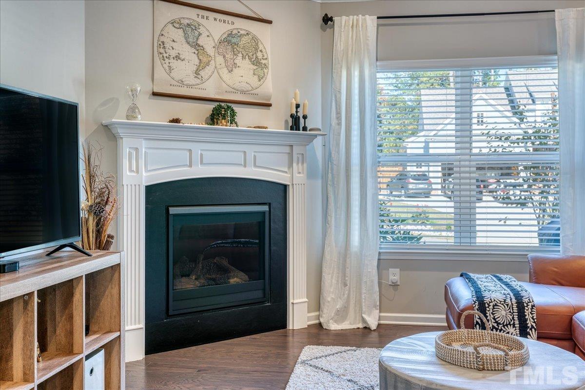 6328 Grace Lily Drive Raleigh, NC 27607 - Photo 10 of 27 a living room with furniture a fireplace and a window