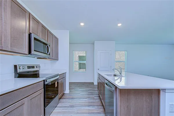 a view of kitchen with cabinets and wooden floor