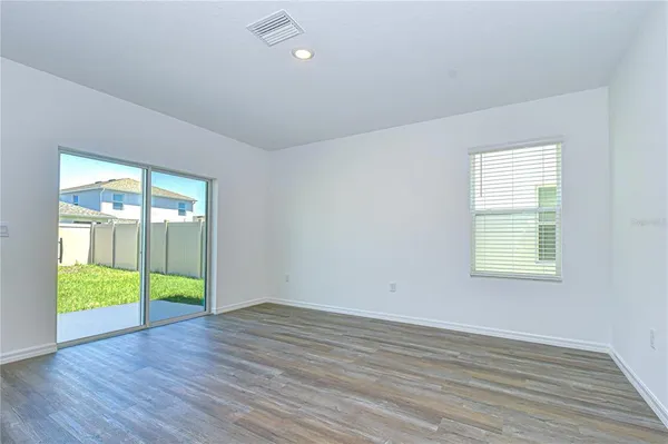 a view of an empty room and closet area