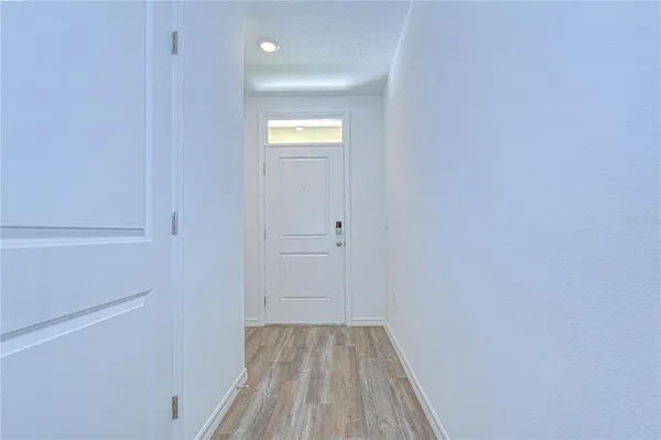 a kitchen with a sink and wooden floor