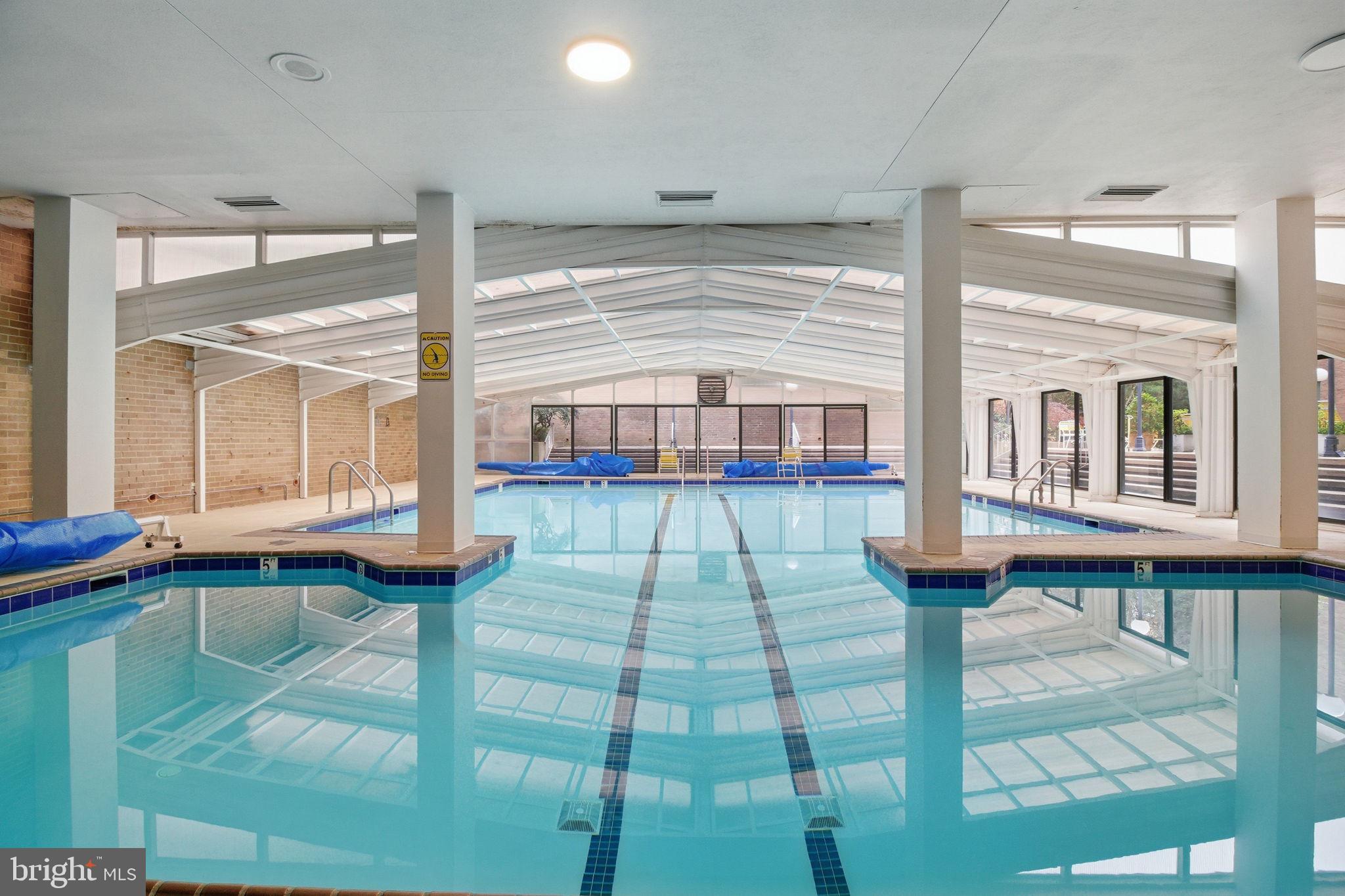 4100 Cathedral Avenue Northwest, Unit 818 Washington, DC 20016 - Photo 12 of 15 a room with lots of furniture and windows