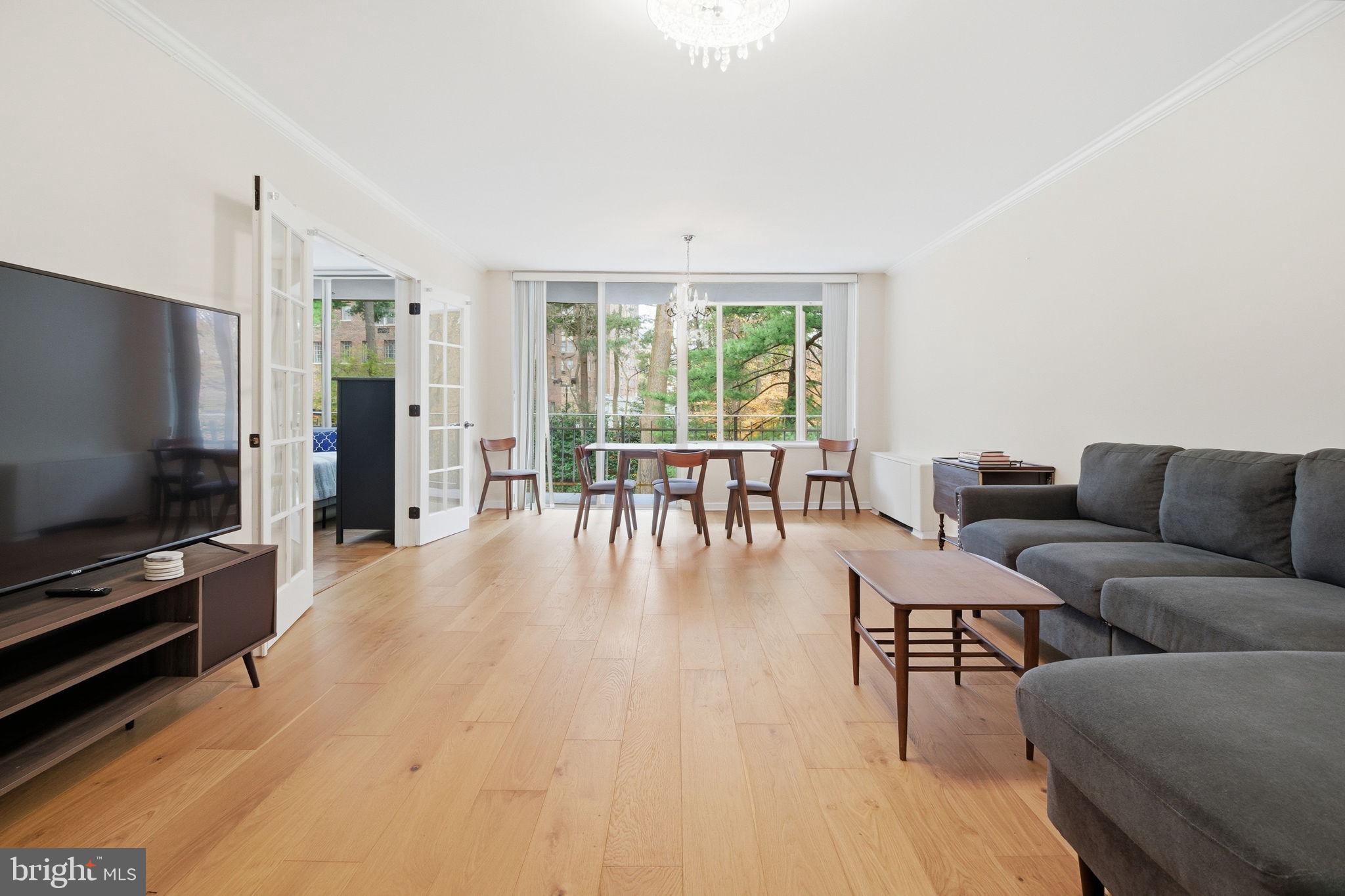 4100 Cathedral Avenue Northwest, Unit 818 Washington, DC 20016 - Photo 3 of 15 a living room with furniture and a flat screen tv