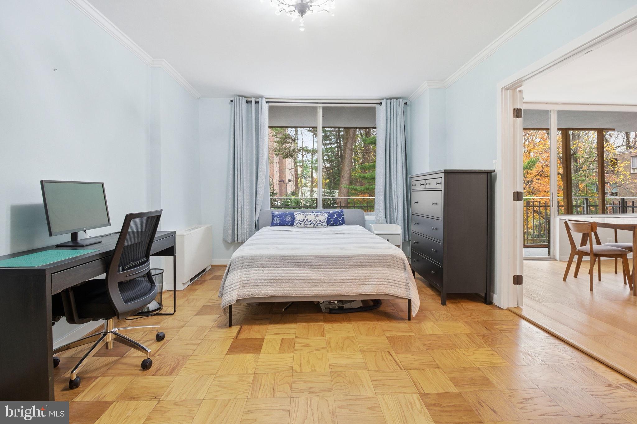 4100 Cathedral Avenue Northwest, Unit 818 Washington, DC 20016 - Photo 5 of 15 a spacious bedroom with a bed and large windows