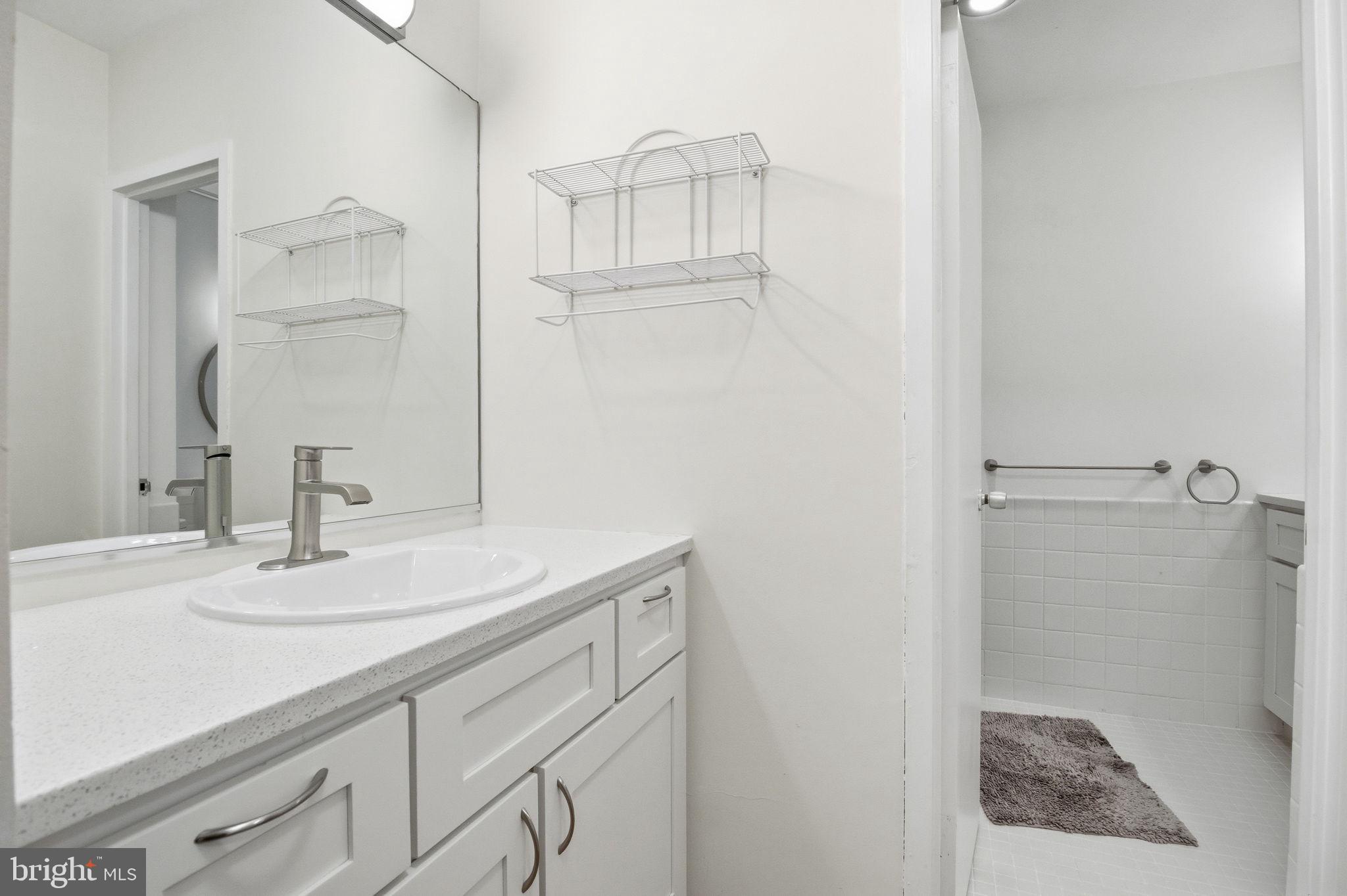 4100 Cathedral Avenue Northwest, Unit 818 Washington, DC 20016 - Photo 7 of 15 a bathroom with a sink and a mirror