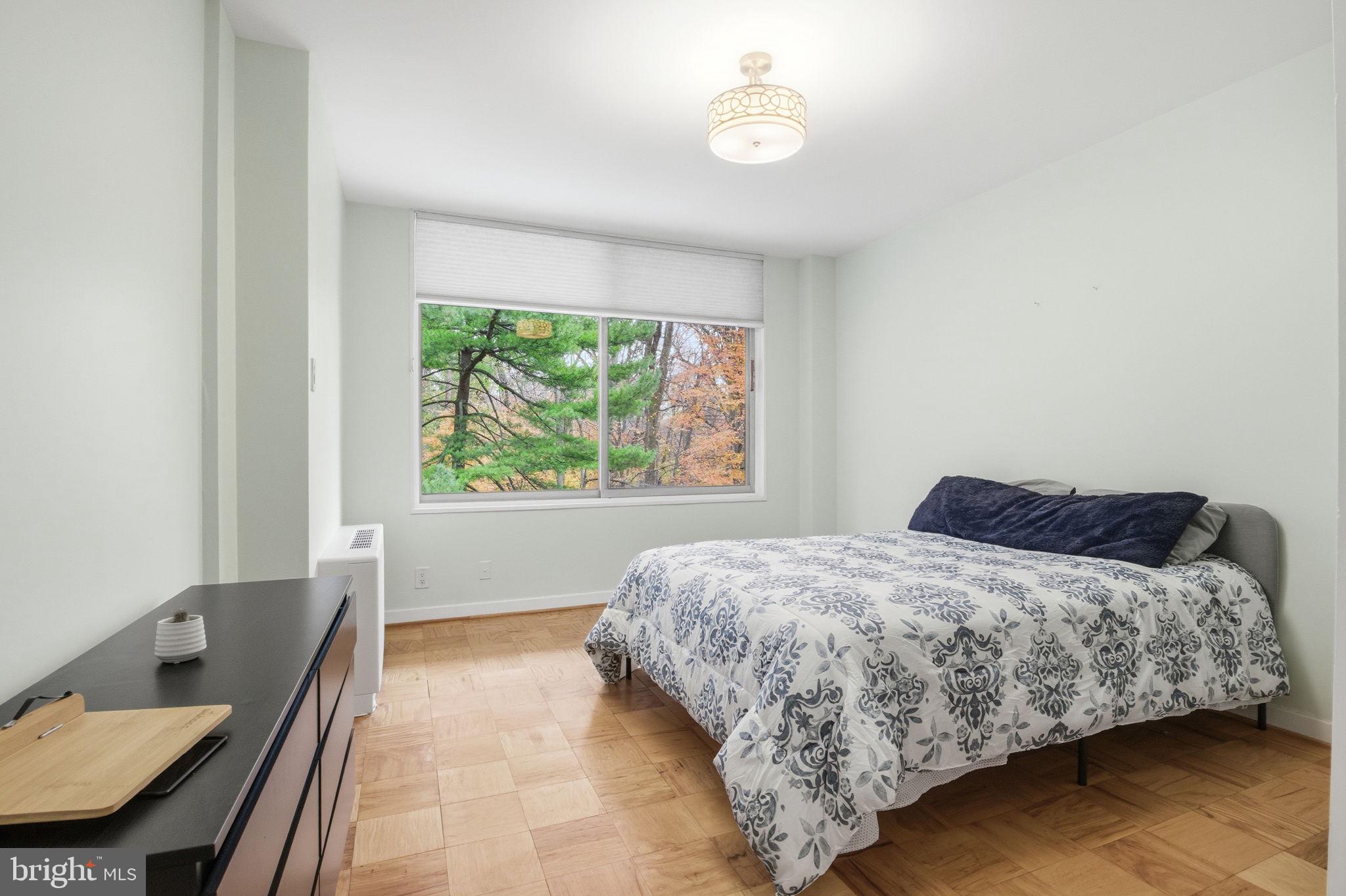 4100 Cathedral Avenue Northwest, Unit 818 Washington, DC 20016 - Photo 8 of 15 a bedroom with a bed window and a table