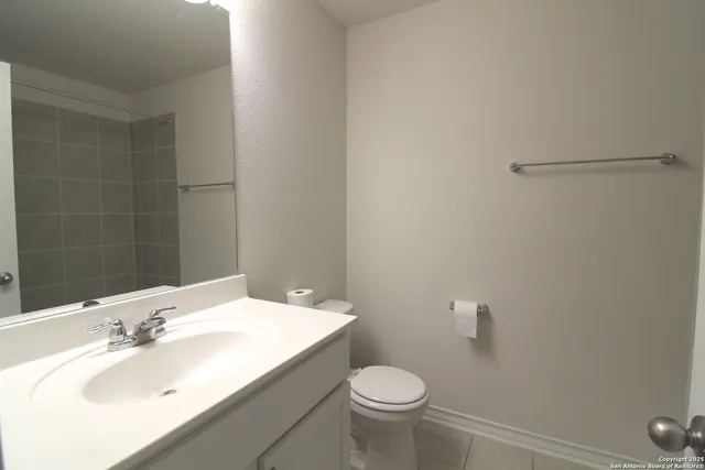 a bathroom with a sink toilet and vanity