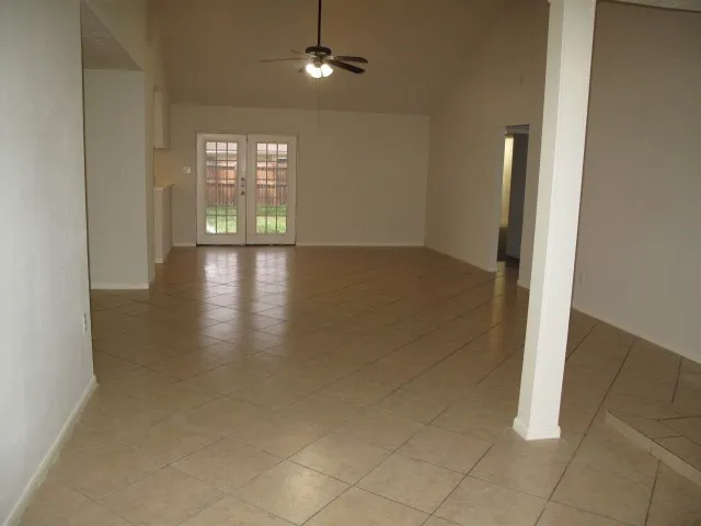 an empty room with windows and closet