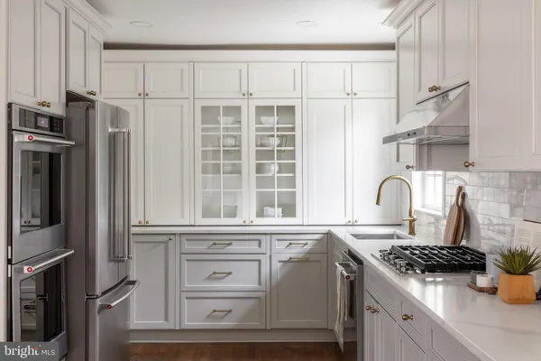 a kitchen with granite countertop a sink stove and refrigerator