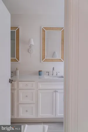 a bathroom with a sink vanity and mirror