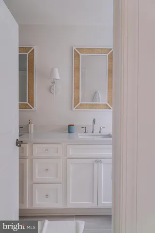 a bathroom with a sink vanity and mirror